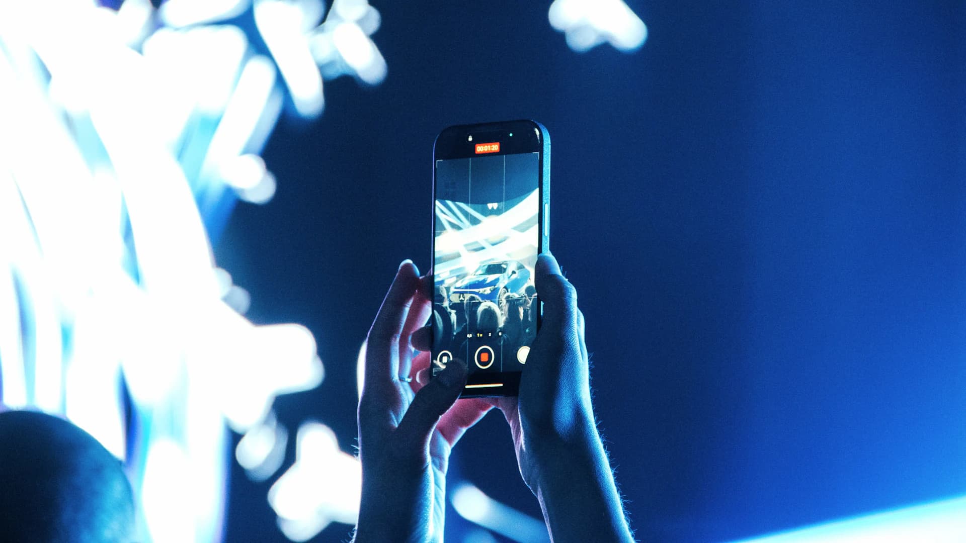A phone held up in a crowd